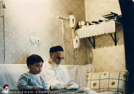 Imam eating with his grandson