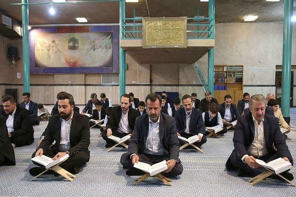 A group of reciters recite collectively at a Quranic session held on 43rd anniversay of Islamic revolution victory  in Hosseinieh Jamaran.